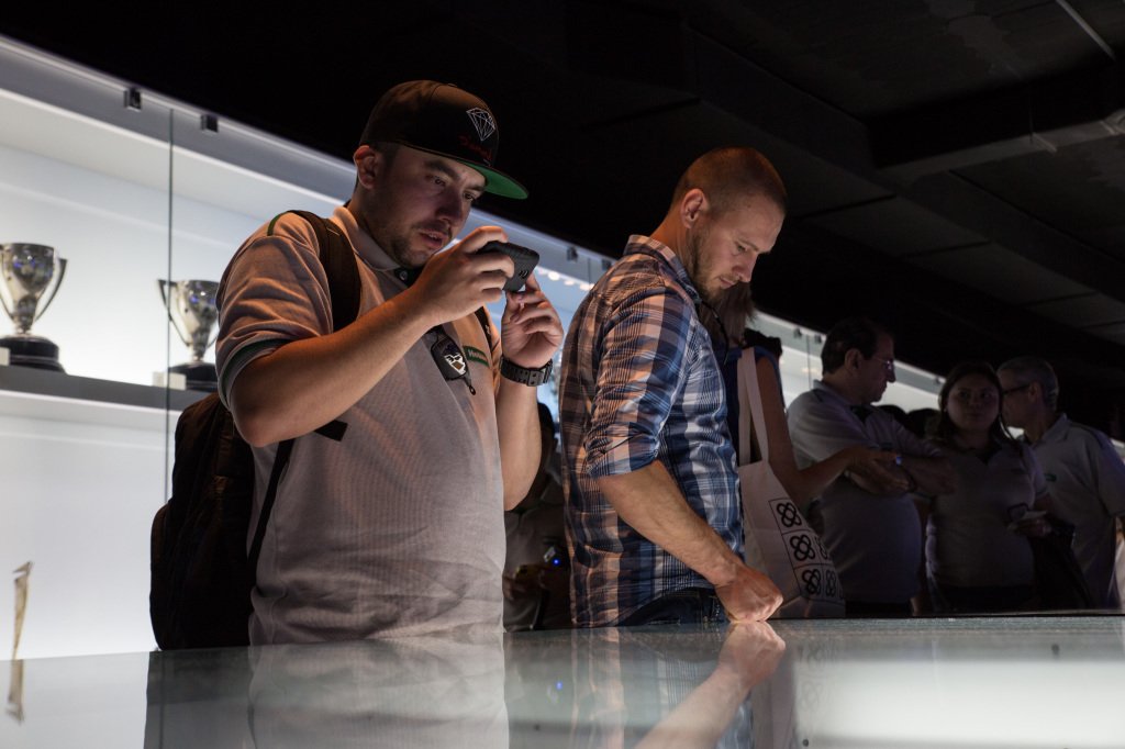 men taking photos of the exhibition in camp nou football arena comercial photography example for mode media webpage