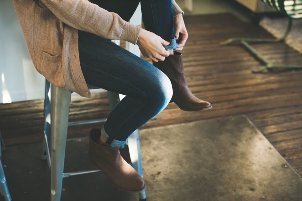 Woman adjusting her blue jean hems